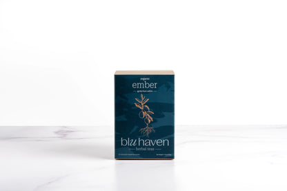 Blu Haven Ember herbal tea box packaging containing sachet tea bags standing on a white marble surface.