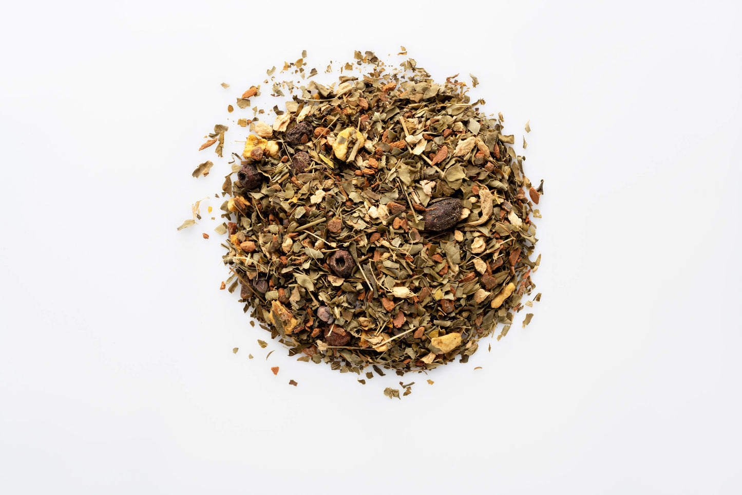 Top down view of a pile of organic loose leaf herbal tea blend showing dried herbs and spices.
